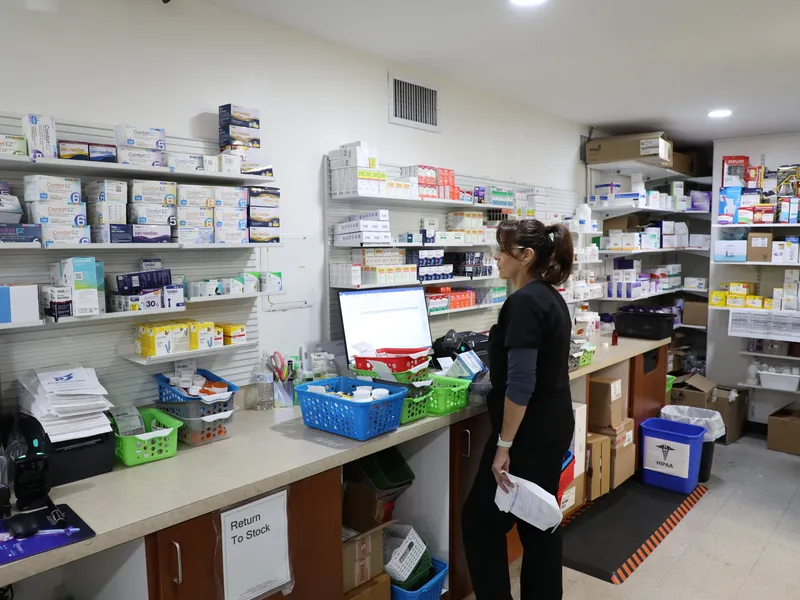 Licensed pharmacist filling a prescription at Pharmacy 1