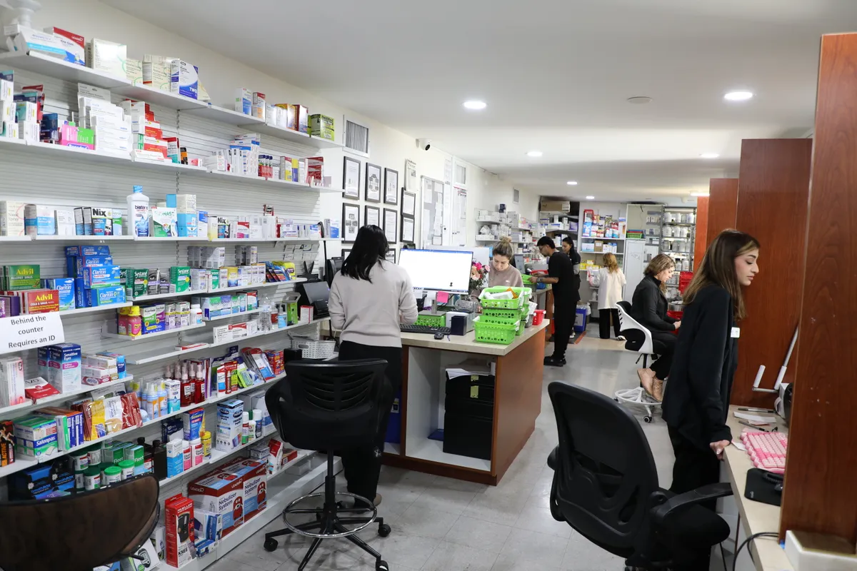 Inside Pharmacy 1 — staff helping patients with prescriptions
